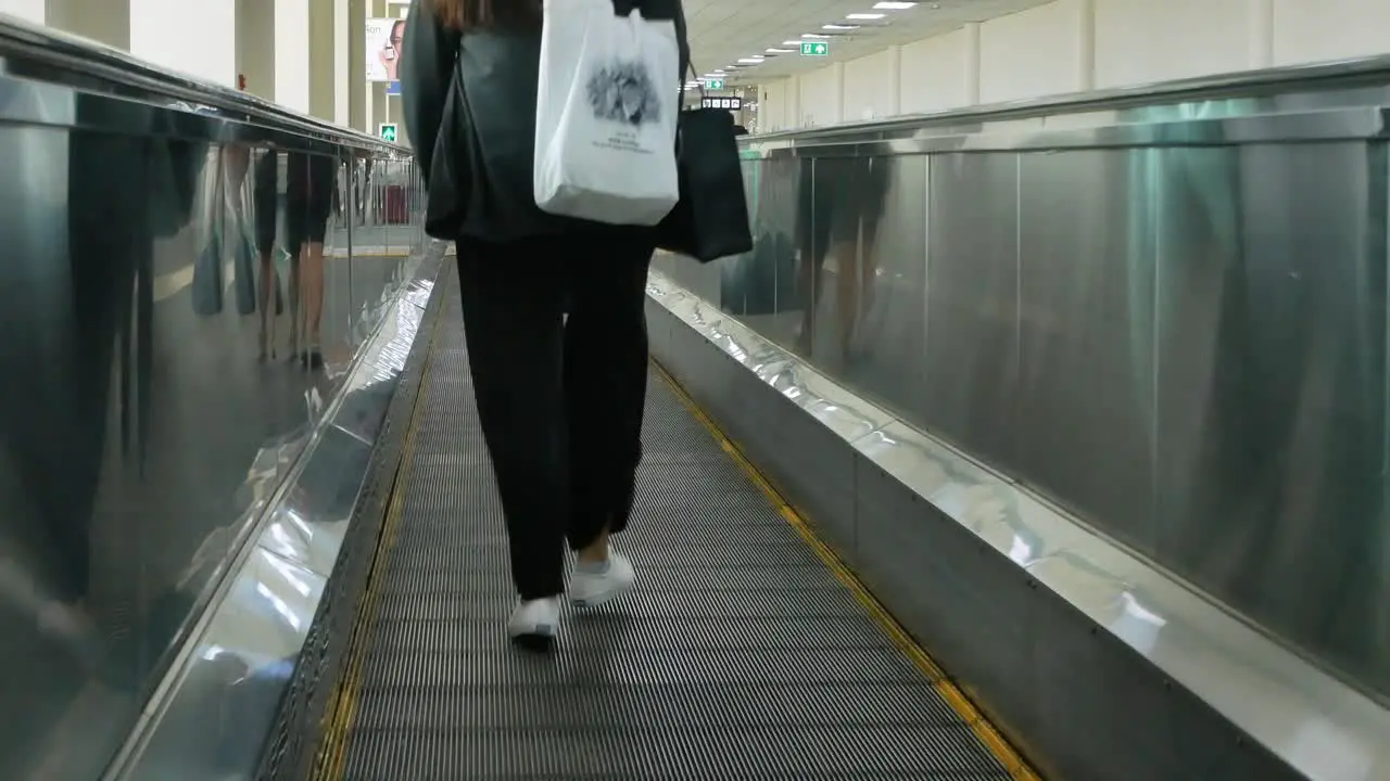 Passenger on escalator in the terminal of Donmuang inbternation airport