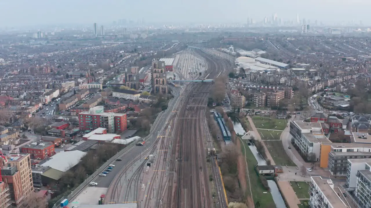 Drone shot over dense train tracks heading into London