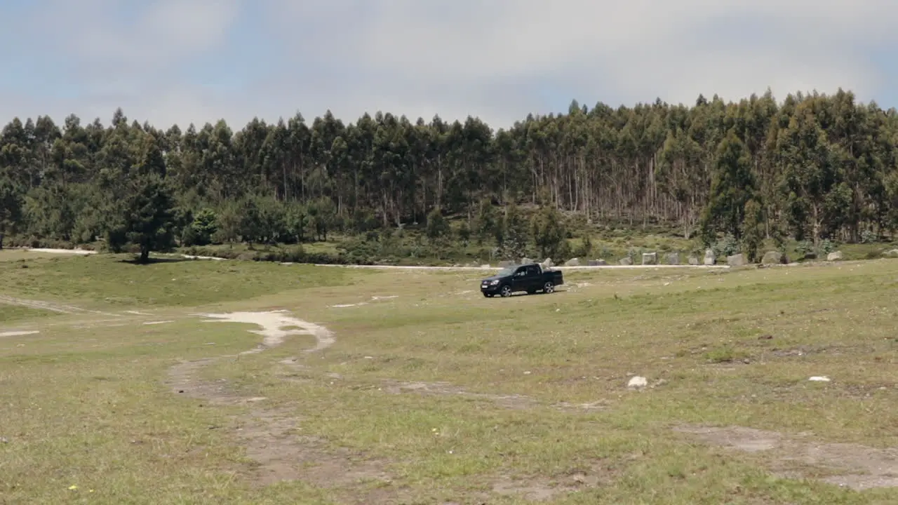 Pickup truck driving across big plain