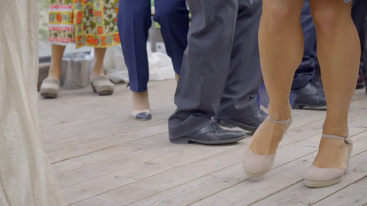 Ground Shot Of People Dancing Over Wooden Floor During Ceremony