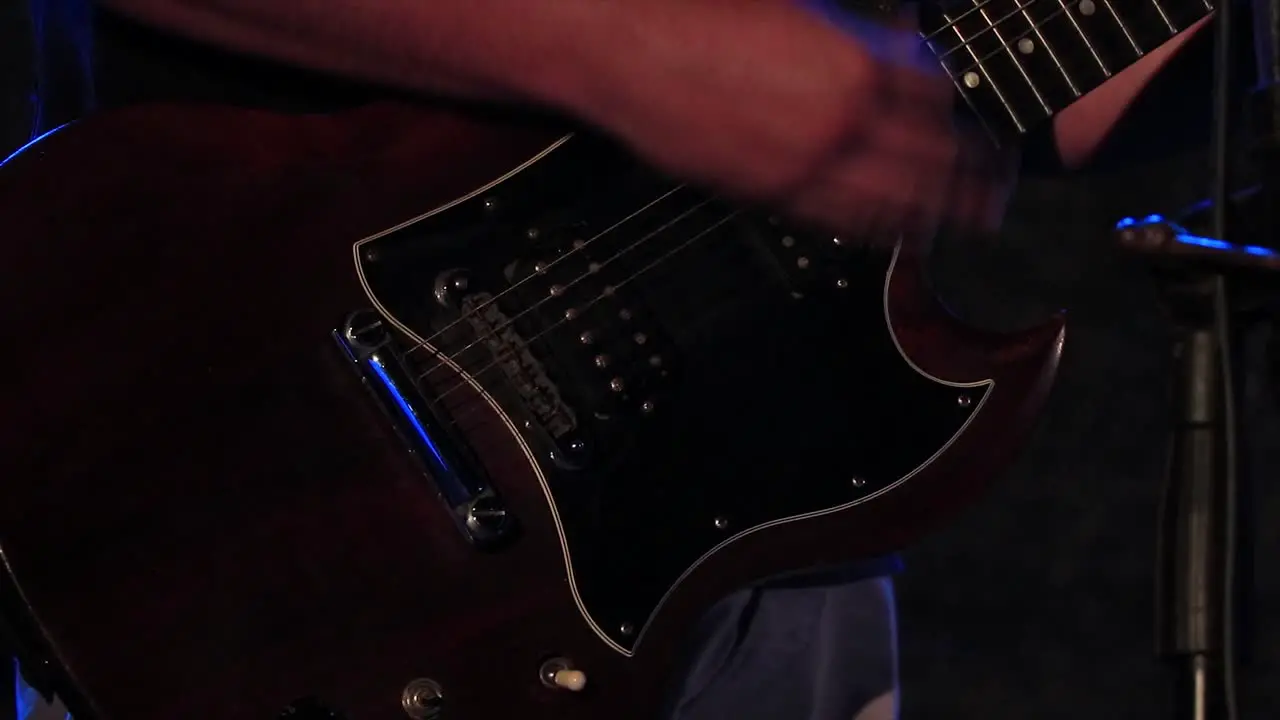 Guitarist playing rock music on a stage live