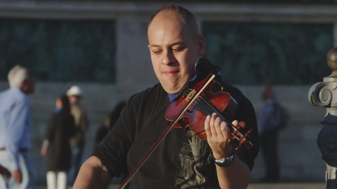 Violinist plays his instrument while busking and performing on the streets of Budapest Hungary