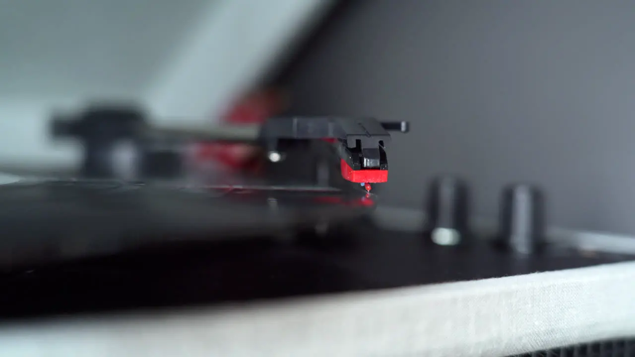 Moving the head of a record player to start playing an old vinyl