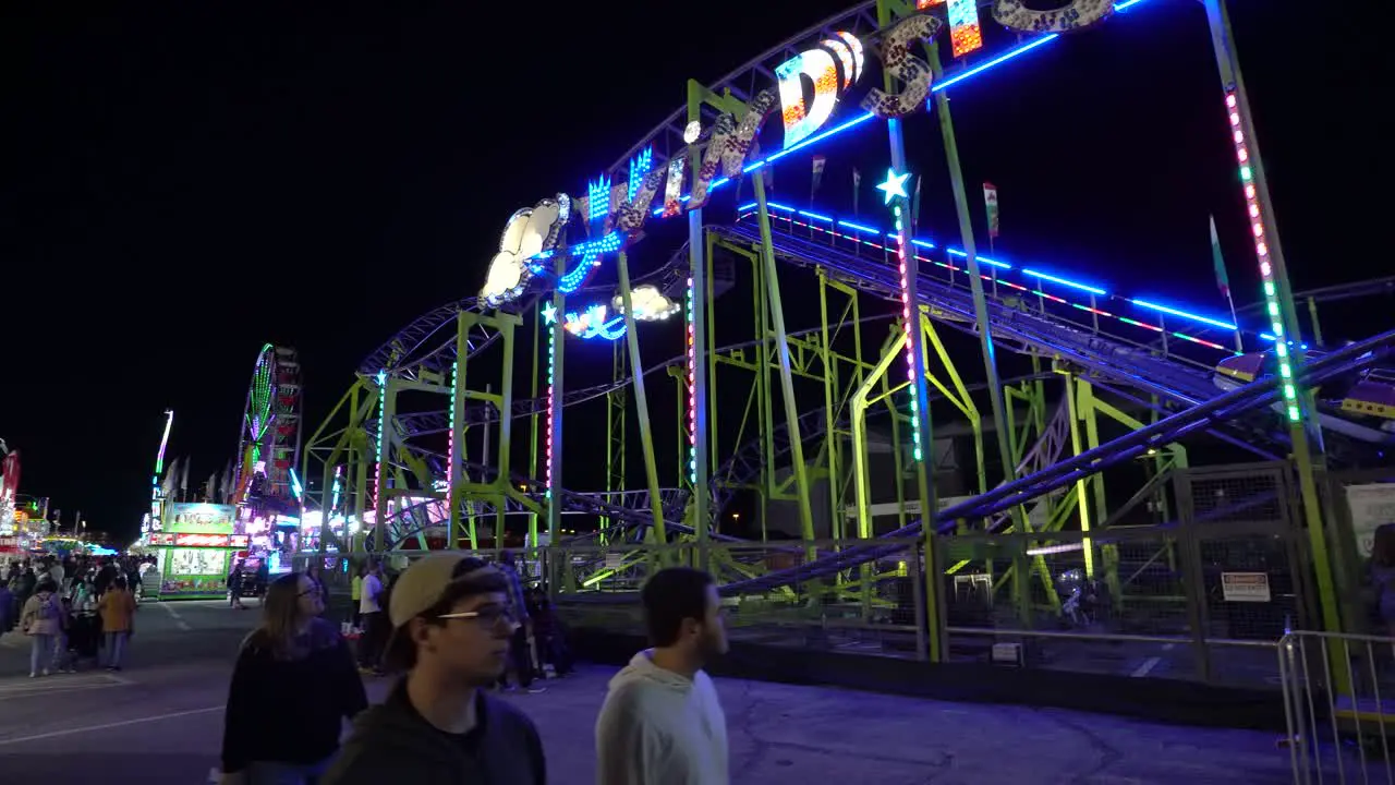 Pan of a Pinfari RC-48 Rollercoaster at The Florida State Fair at Night