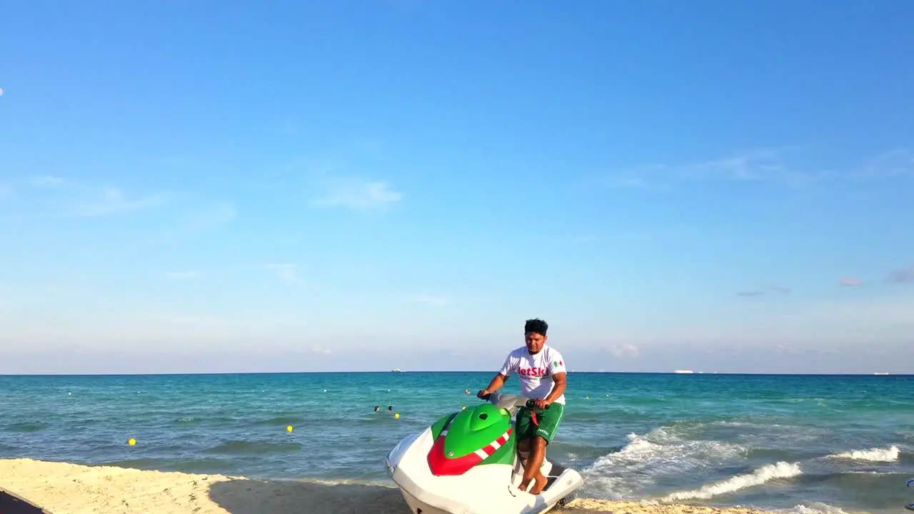 Mexican Man Driving A Jetski At Full Speed From The Water Onto The Sandy Beach In Mexico During Daytime