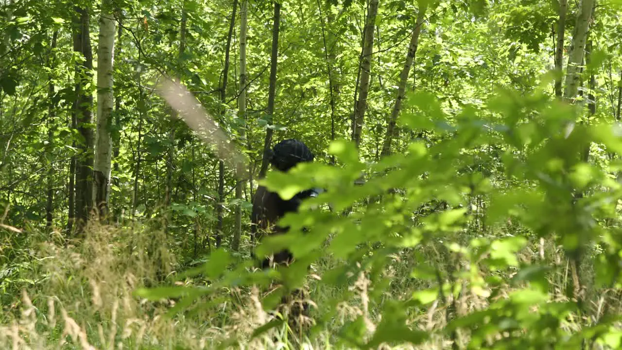 Tactical guy walks through the woods with airsoft