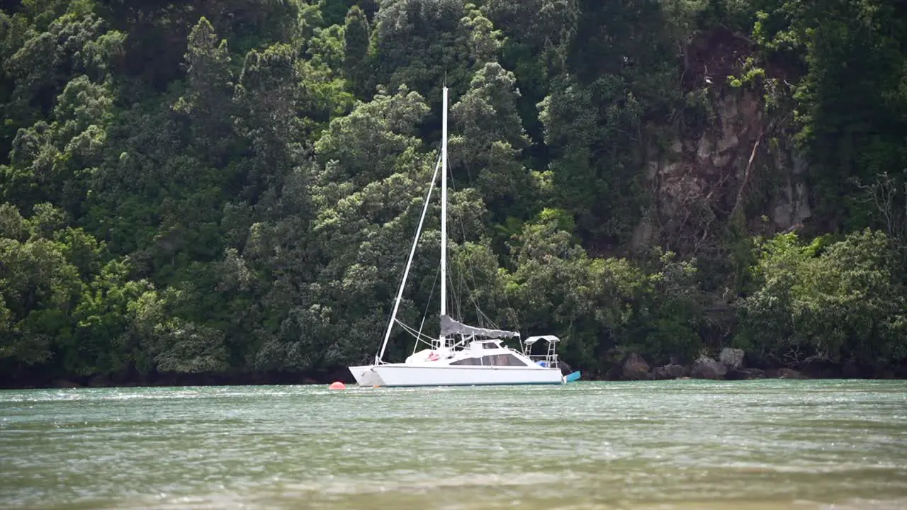 Yacht floating along river at high tide