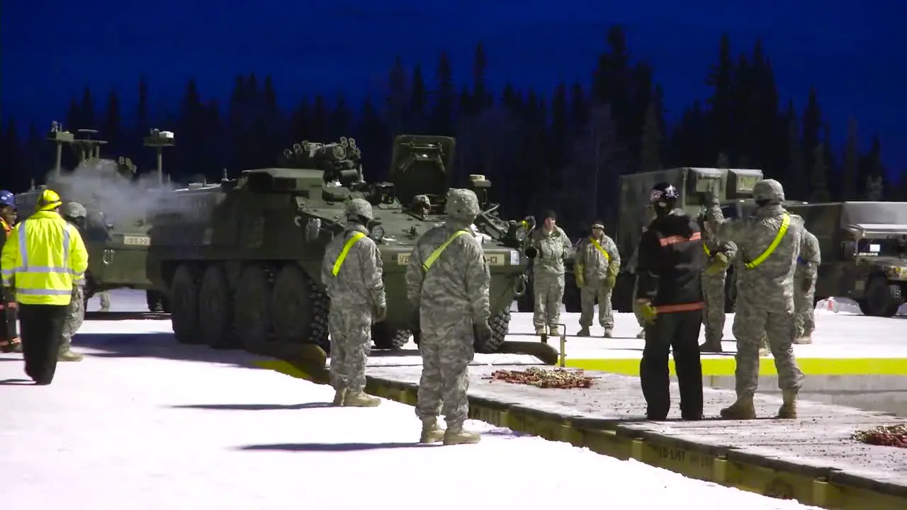 Tanks Are Loaded Onto A Train By Us Military Personnel In The Snow