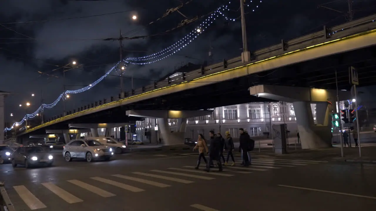 Pedestrians crossing the road on green light