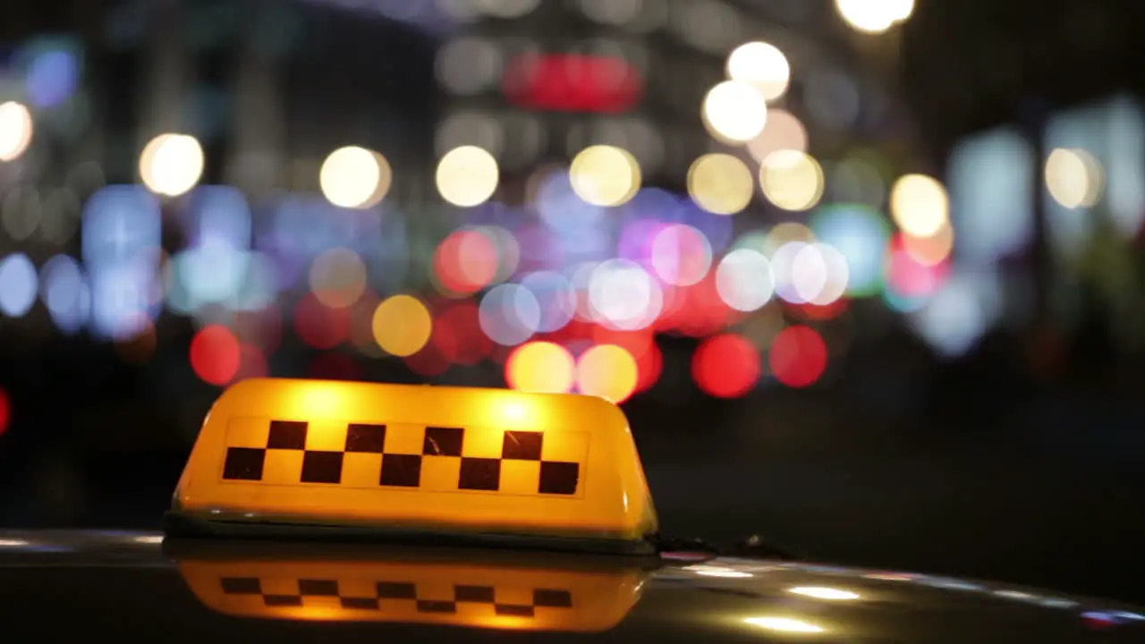 Illuminated taxi cab sign on a city street