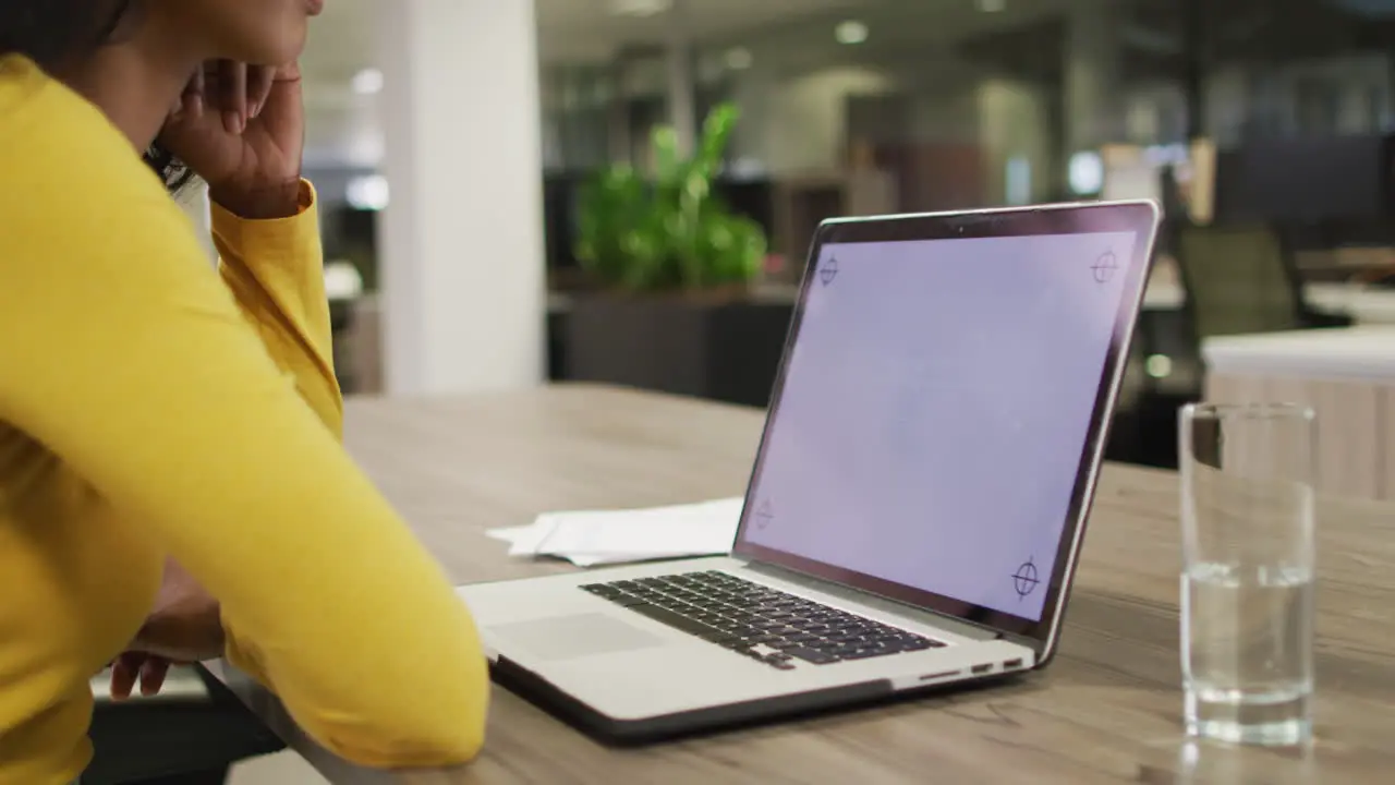 Video of biracial woman using laptop with copy space on screen