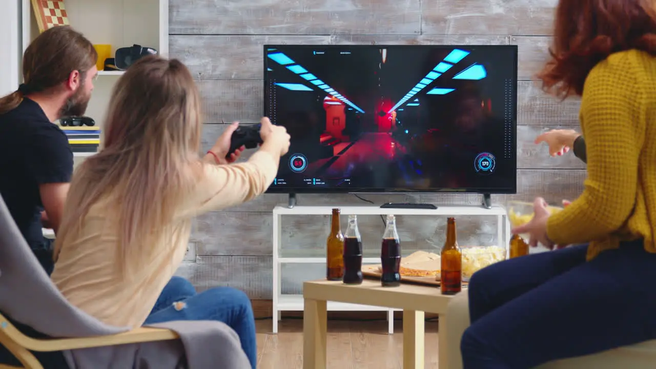 Back view of game over for young woman playing video games