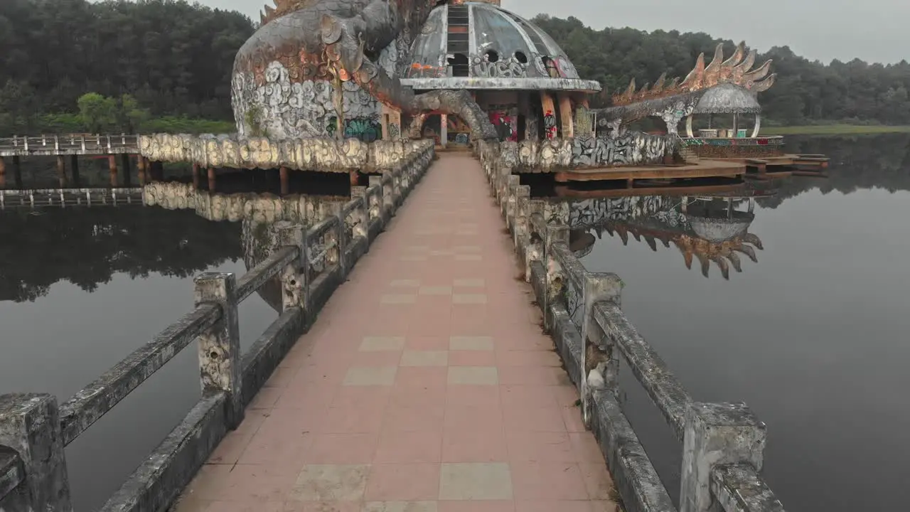 Reveal shot of big dragon at Abandoned waterpark Hue Vietnam aerial