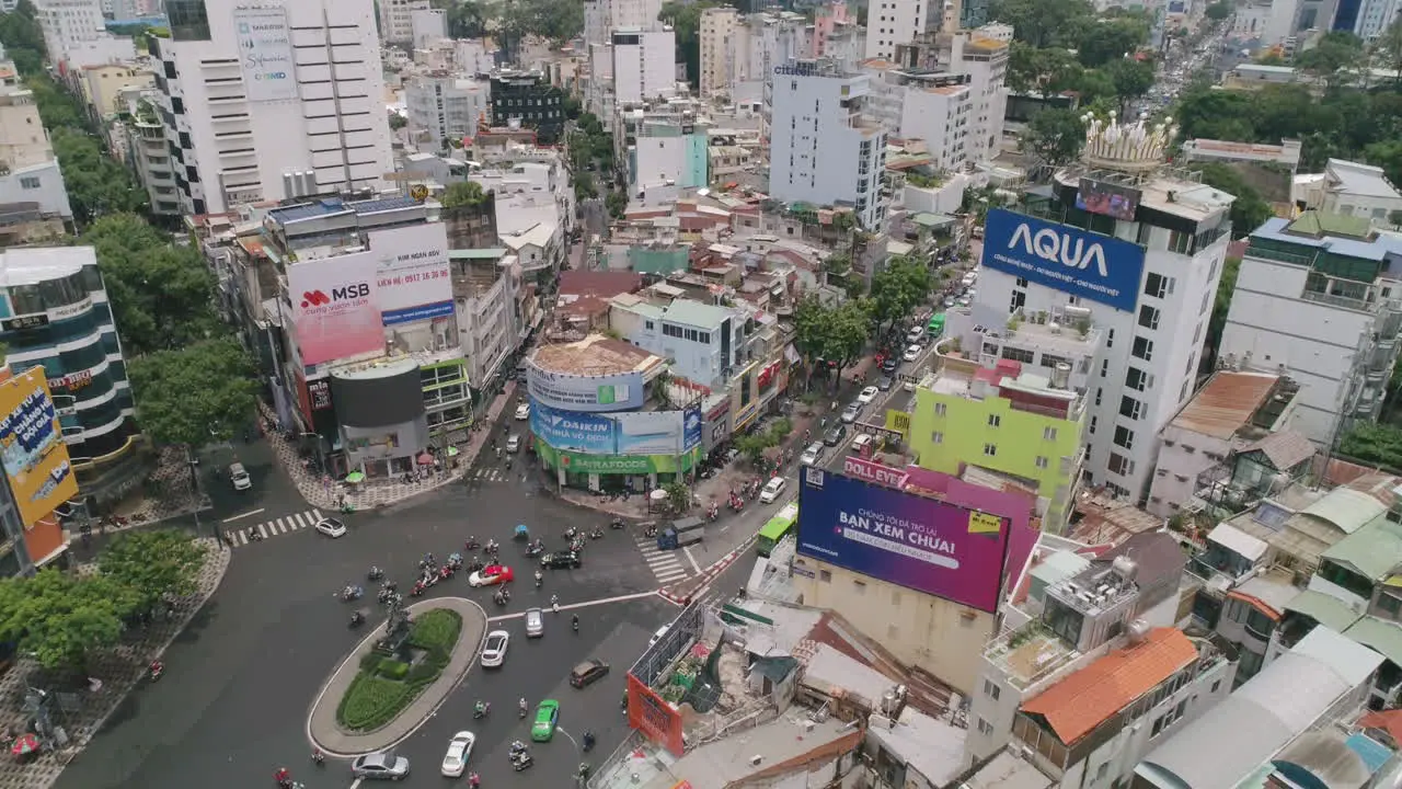 Tilt Down Aerial of busy city roundabout Ho Chi Minh Saigon Slow Motion