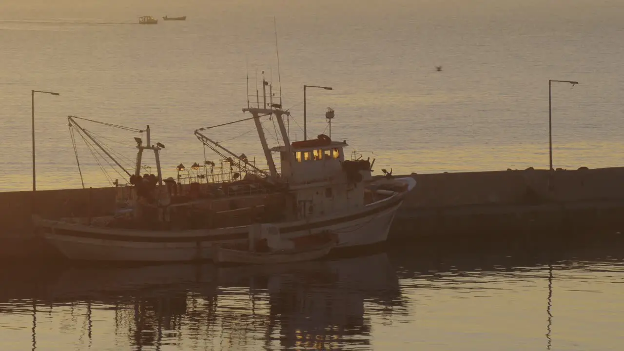 Fishing ship at anchor in sunset