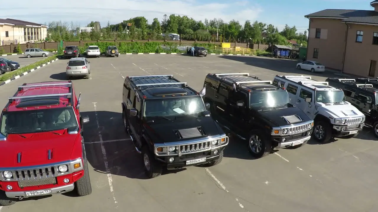 Flying over the row of Hummer cars on parking lot