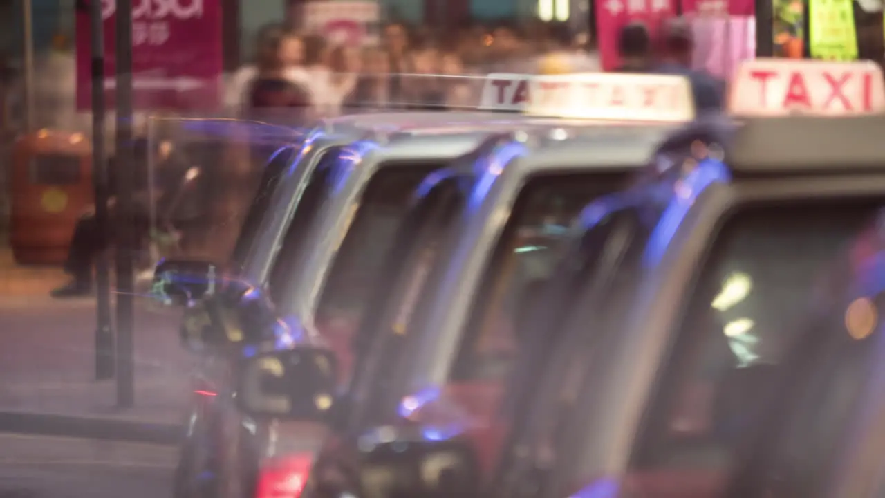 Timelapse of taxi cars waiting for clients in night Hong Kong