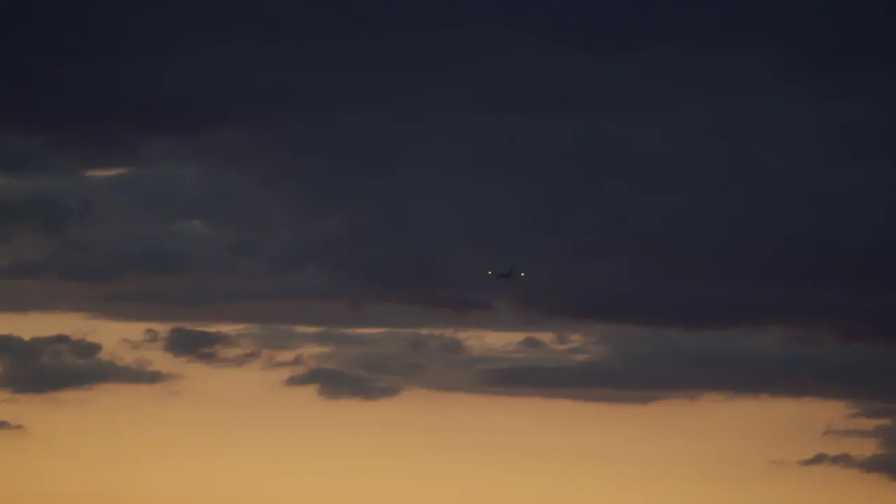 Airplane in the sunset sky