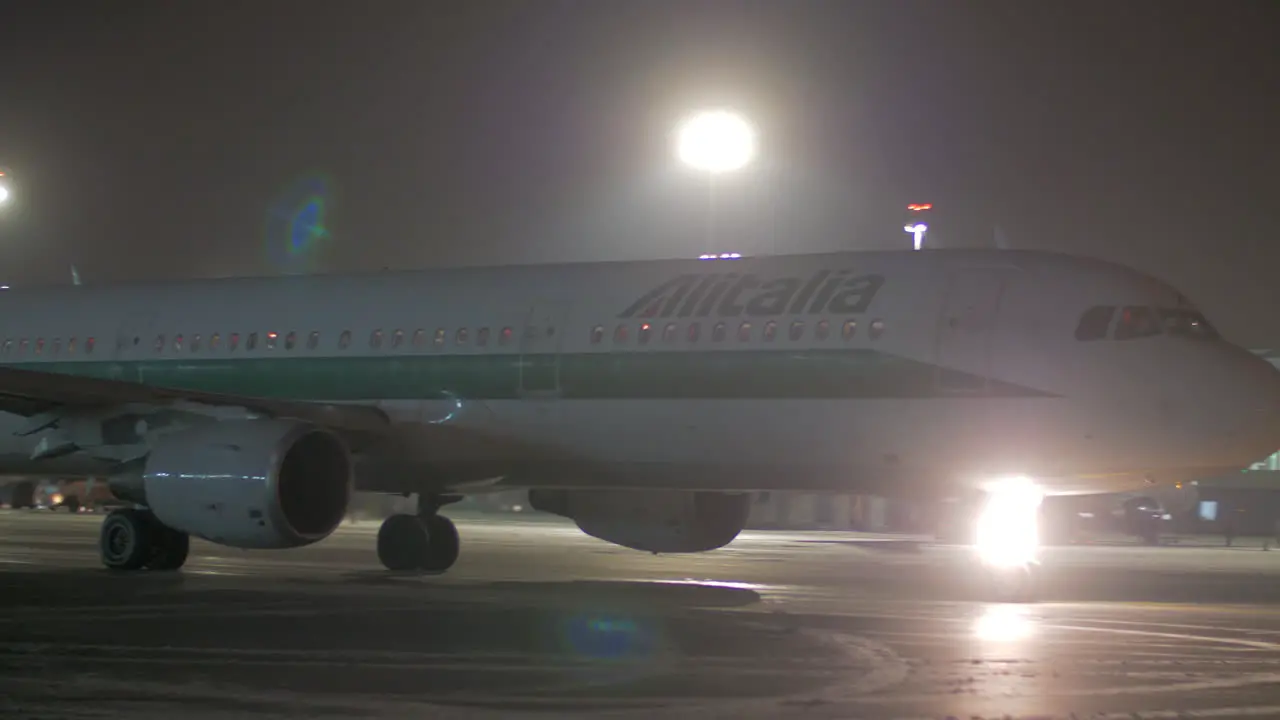 Taxiing aircraft of Alitalia in Sheremetyevo Airport at night Moscow