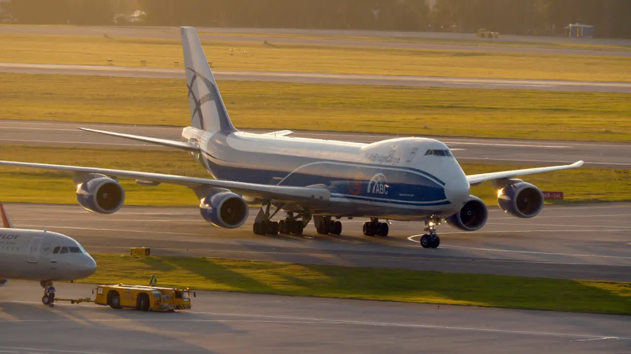 Plane pushback and taxiing cargo Boeing 747