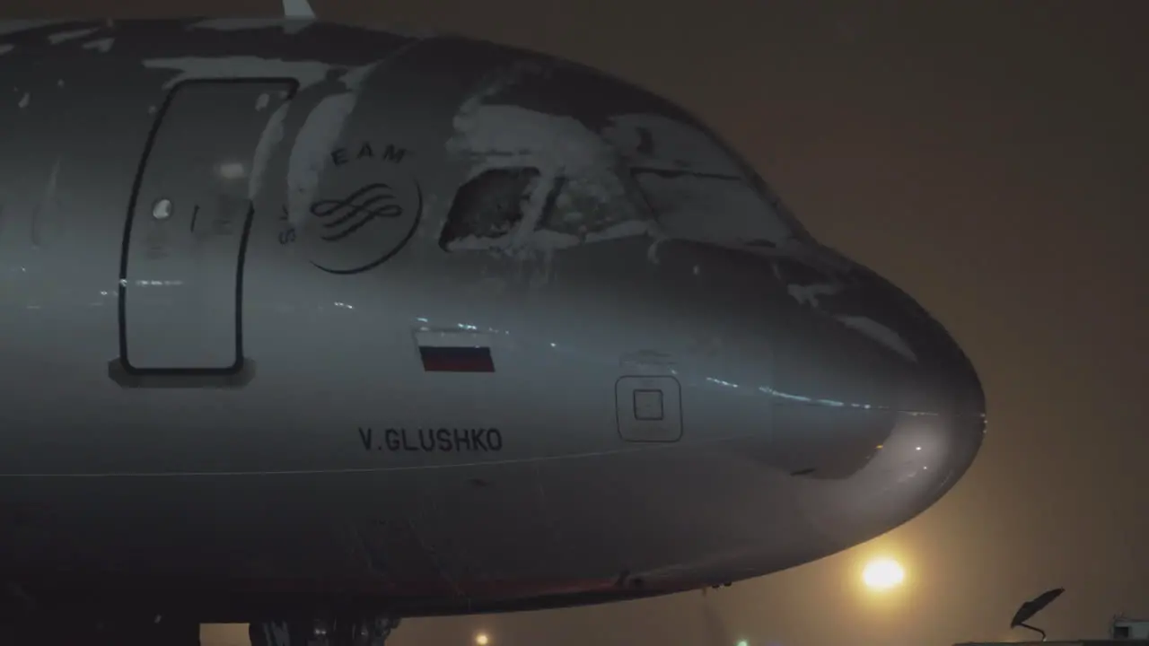 Tug towing Aeroflot A320 airplane at night