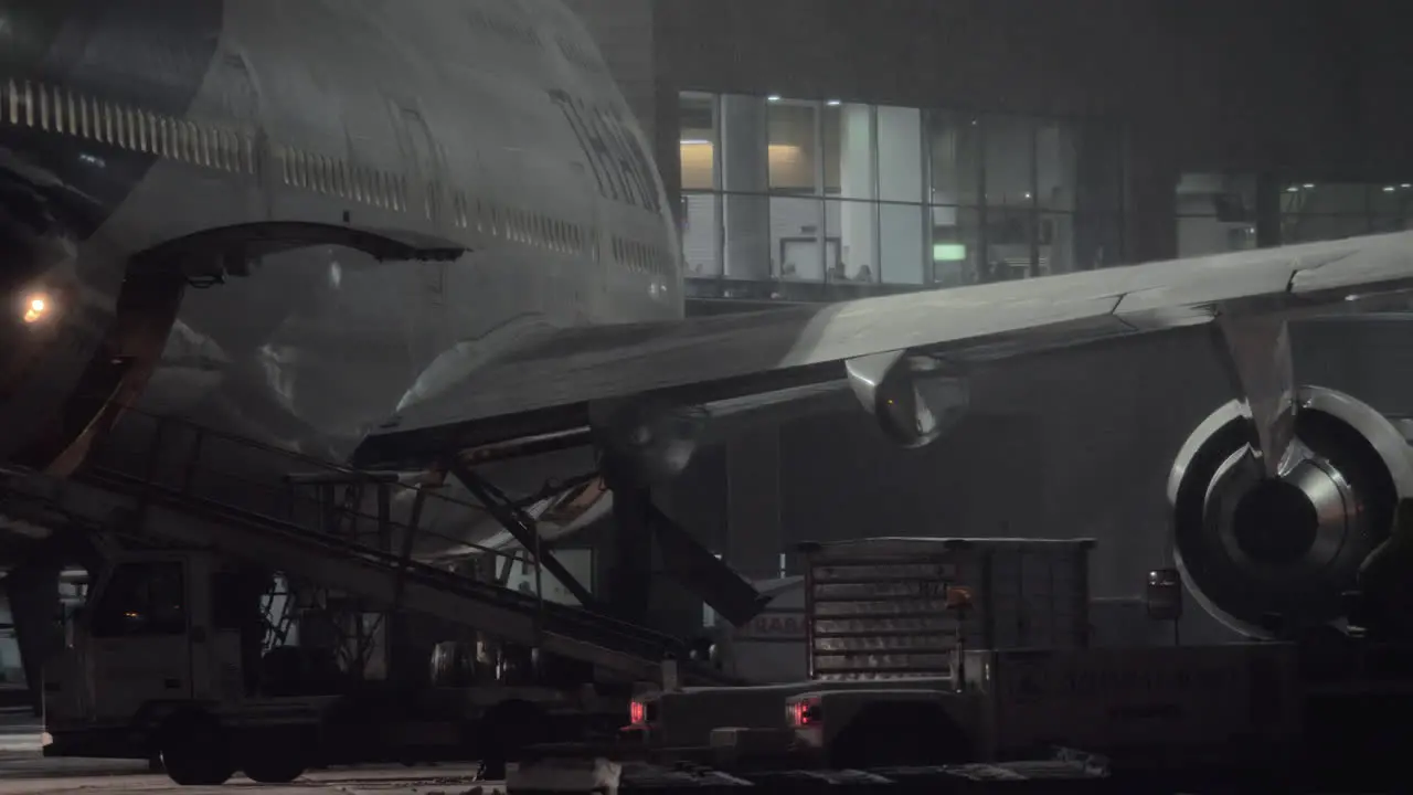 Boeing 747-400 of Thai Airlines is prepared for unloading baggage at night