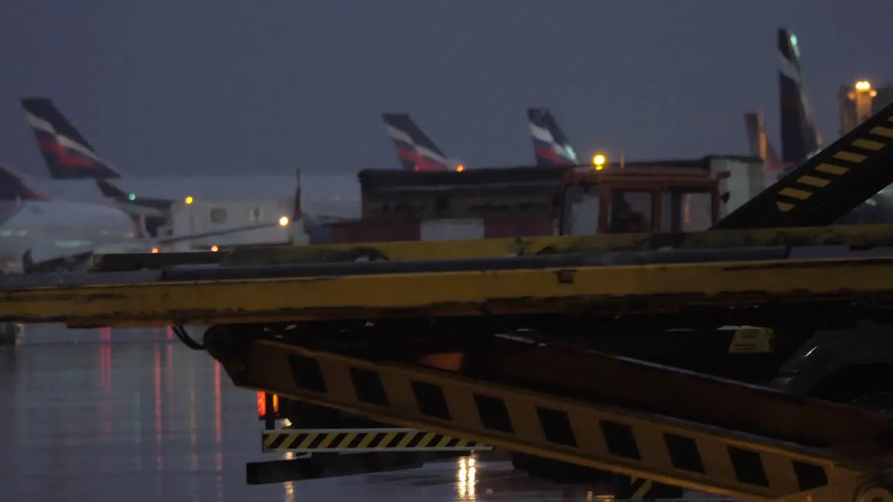 Unloading cargo from plane with container loader