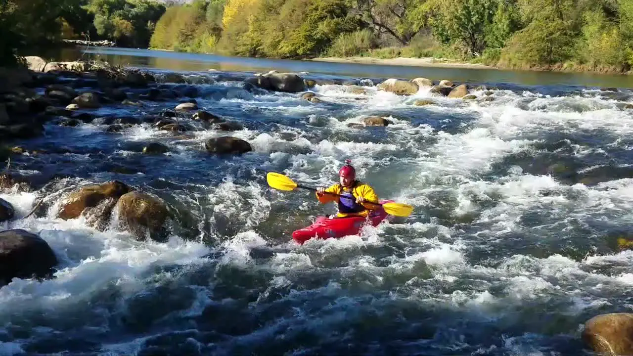 whitewater kayaker going down class 2 rapids