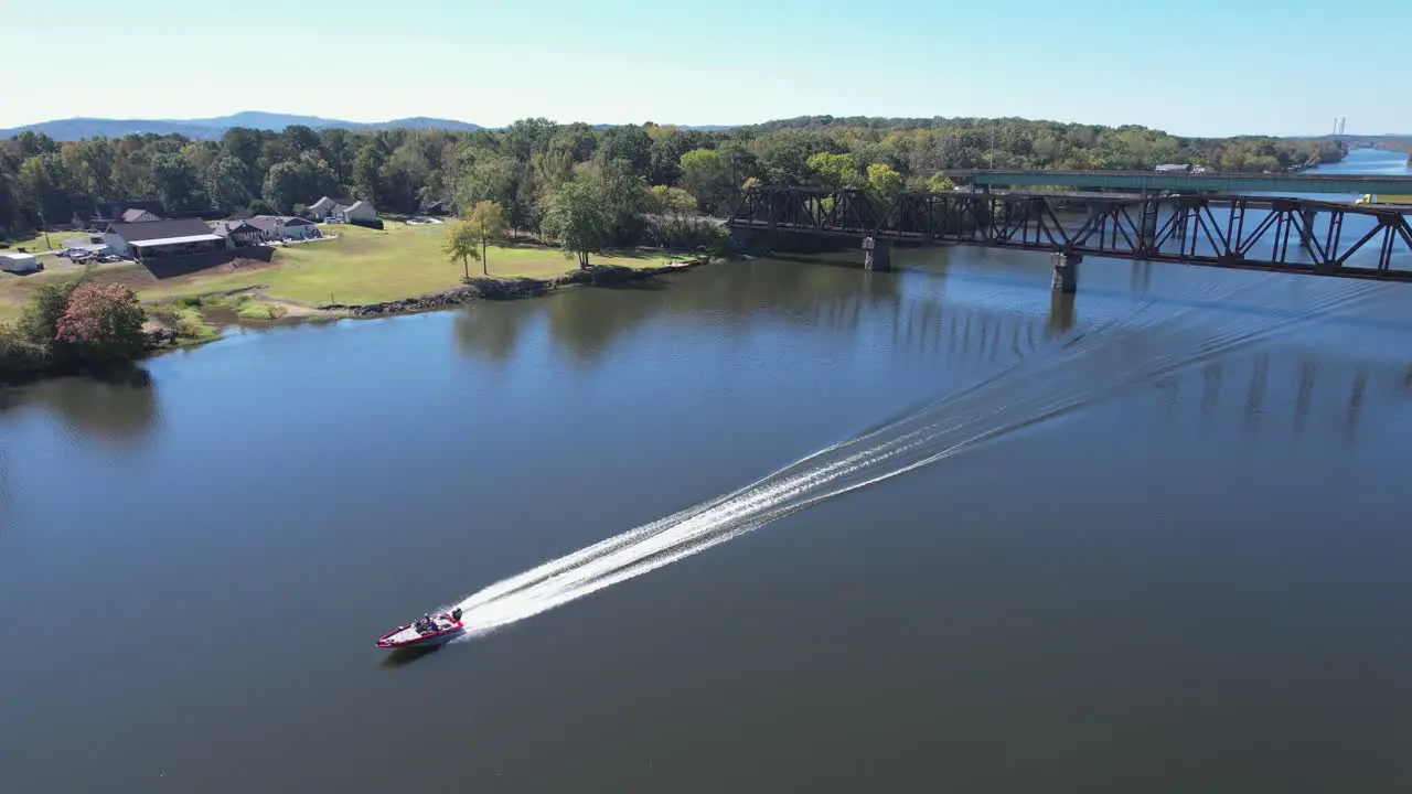 Boat travelling from underneath a railway bridge on the Coosa River