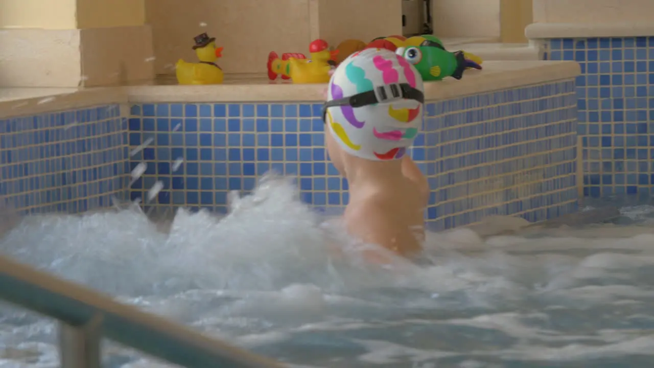 View of boy playing with toy in the kids swimming pool