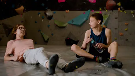 Teenage boys resting in a climbing gym