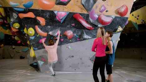 Three friends in a climbing gym