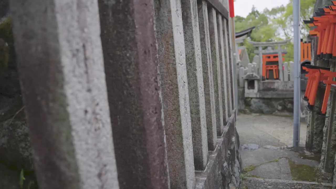 Fushimi Inari Shrine Close Push along temple stone fence Kyoto Japan