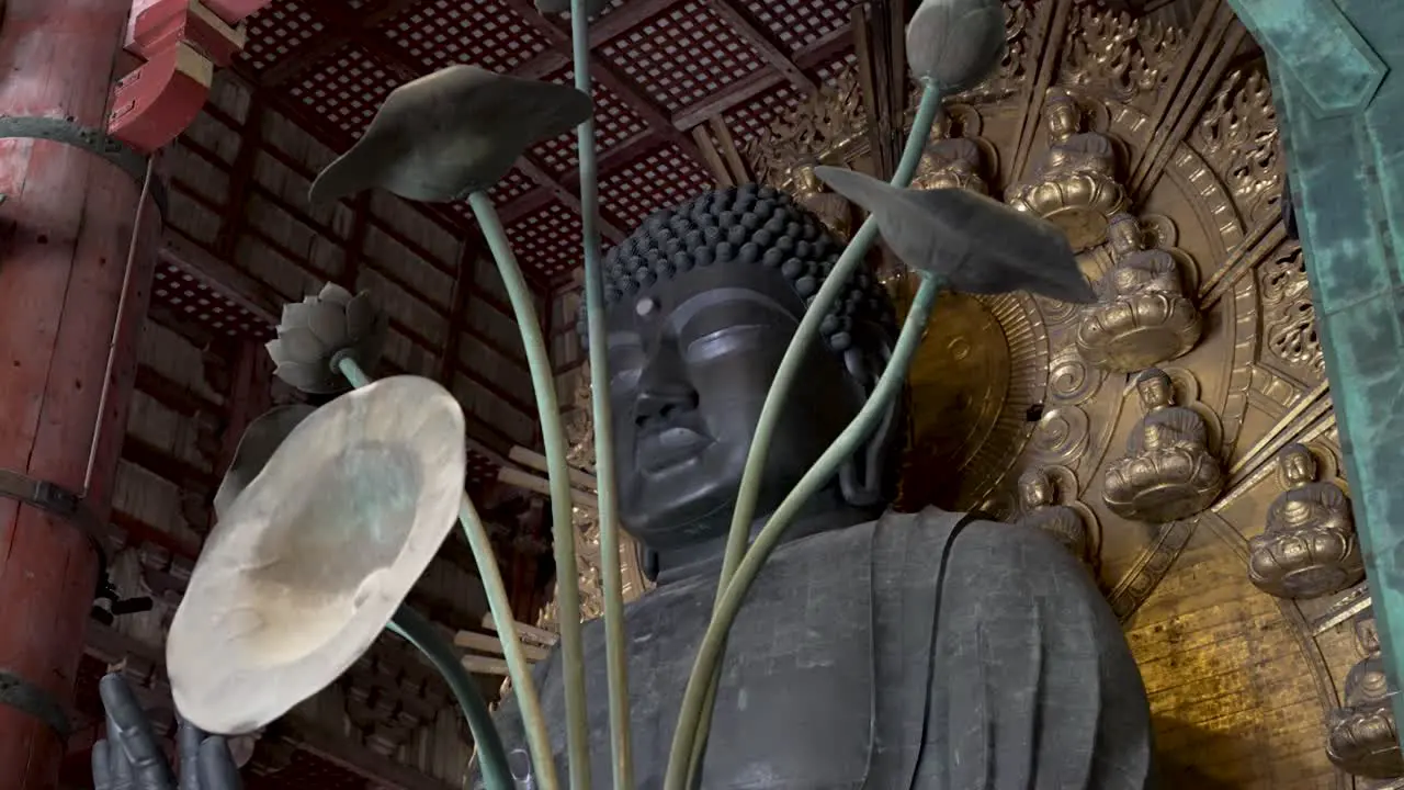 Looking Up At The Great Buddha In The Main Hall At Todaji Through Artistic Metal Flower Petals