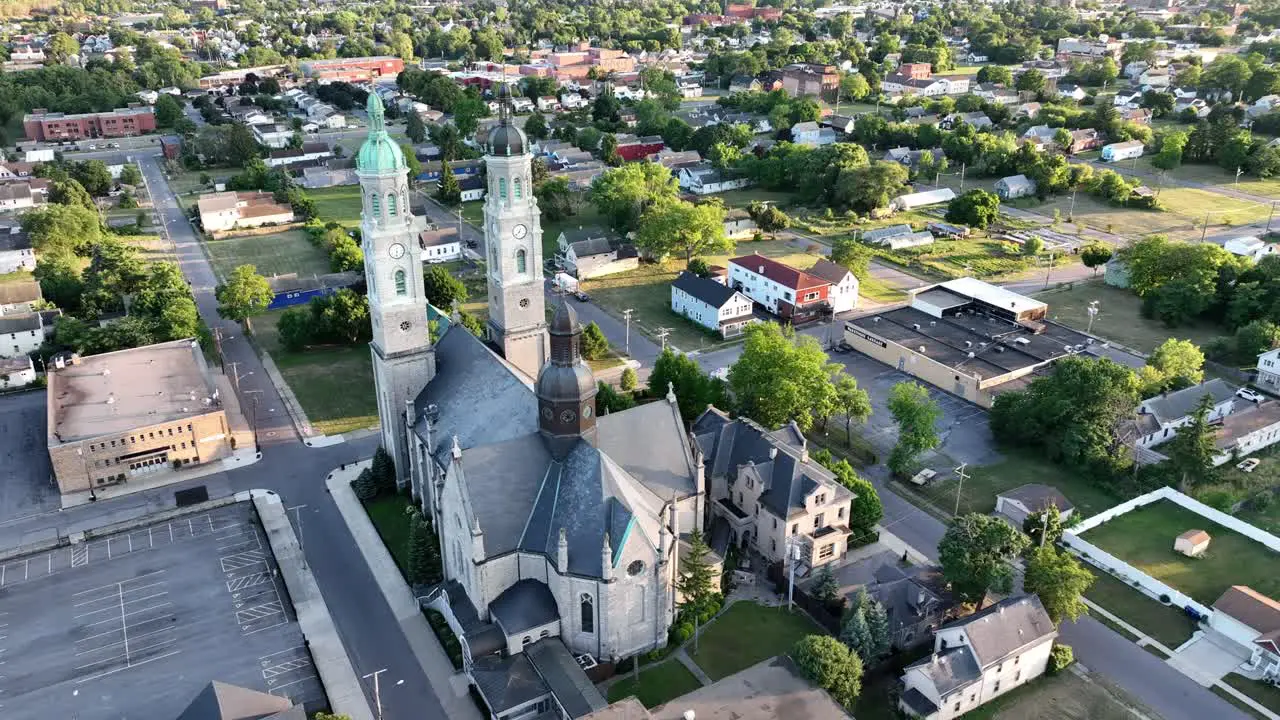 A circling aerial view of the Saint Stanislaus B and M Roman Catholic Church in the light of the setting sun