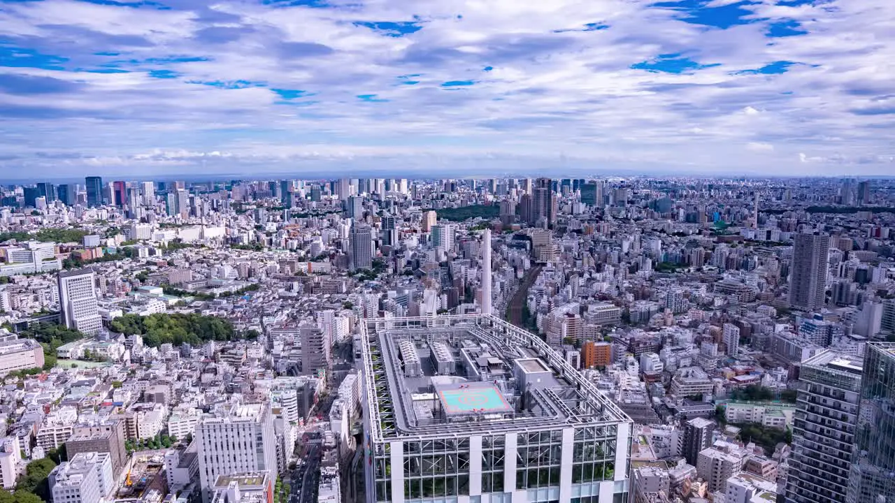 High wide TILT Time-Lapse Tokyo City Skyline Aerial View with Passing Clouds on a Vibrant Day