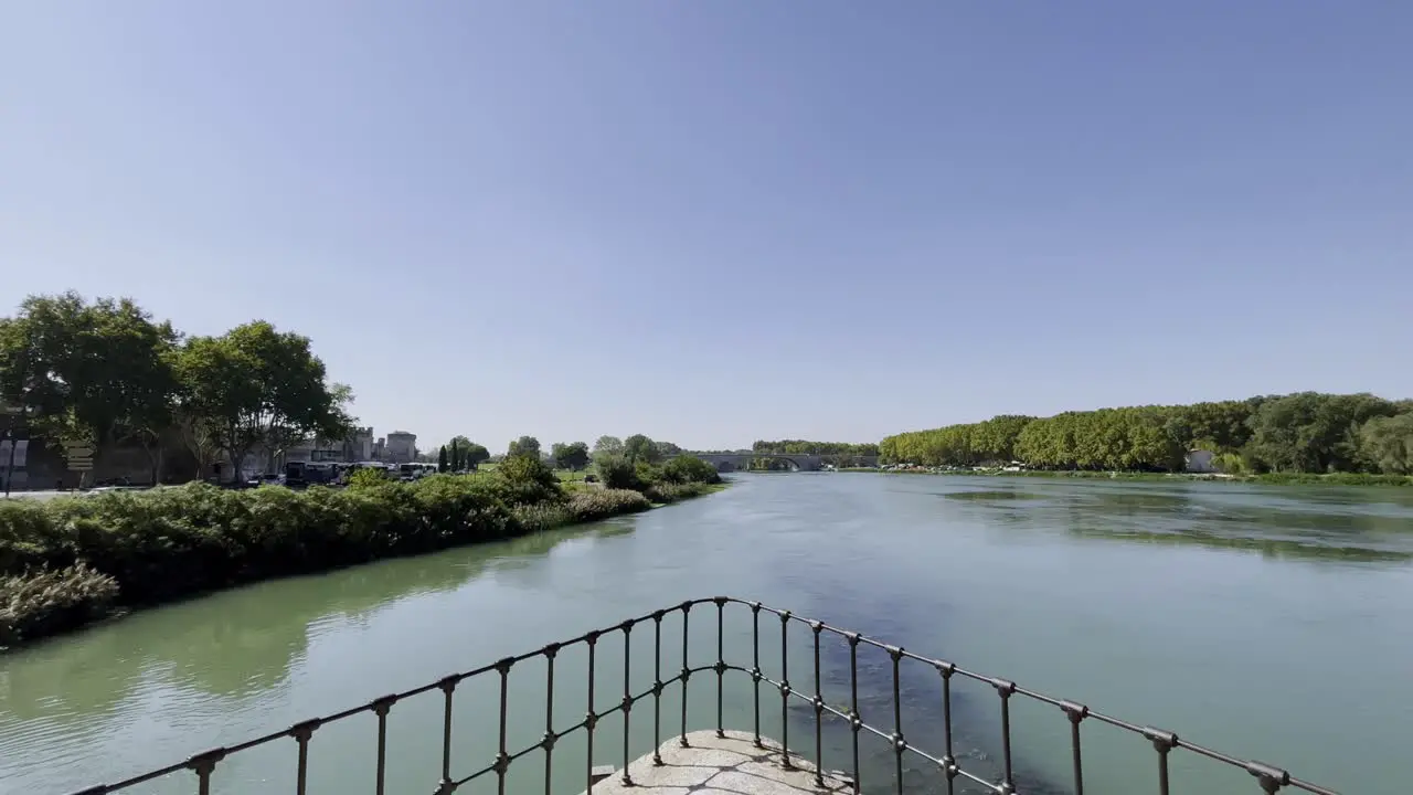 View from half the bridge in Avignon of the river at the city with bridge support in the foreground