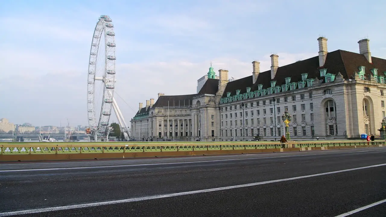 Police convoy of motorbikes in London in Coronavirus Covid-19 lockdown with quiet empty and deserted roads and streets at Westminster Bridge and London Eye in England UK