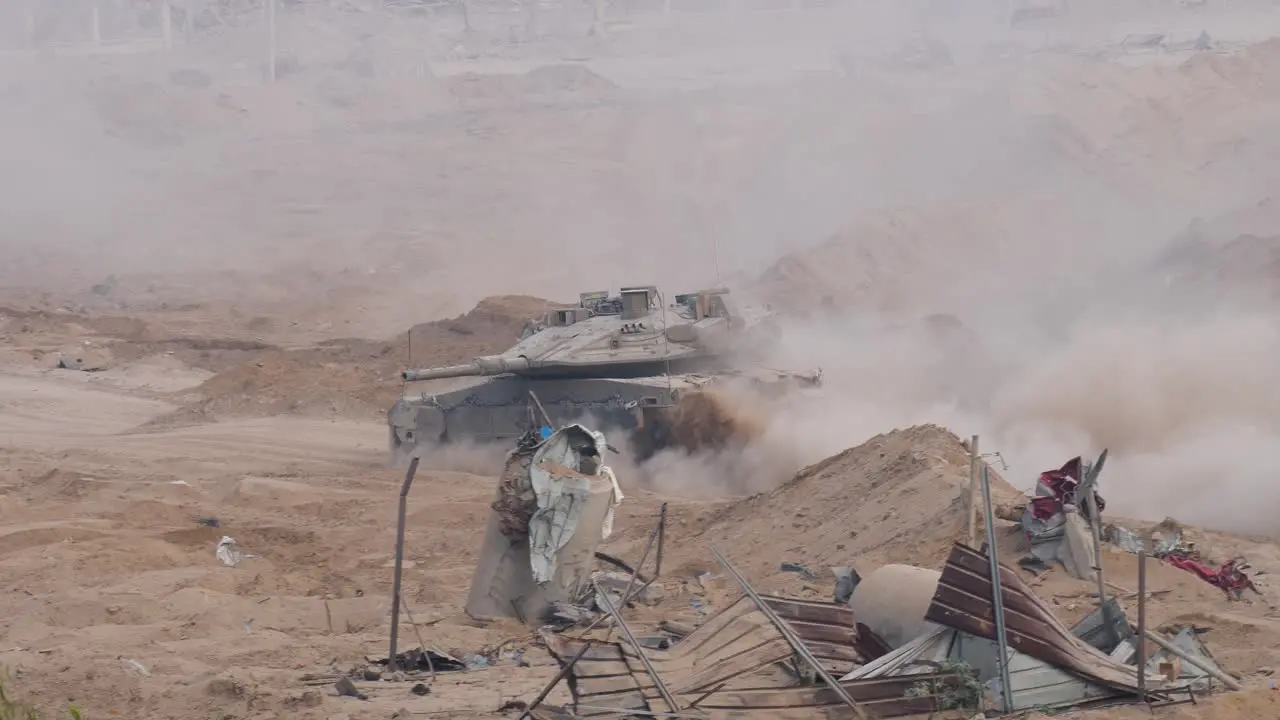 An army battle tank at the border of Gaza Armoured combat fighting vehicle in destroyed city of Gaza dust during Israel–Hamas war conflict 2023