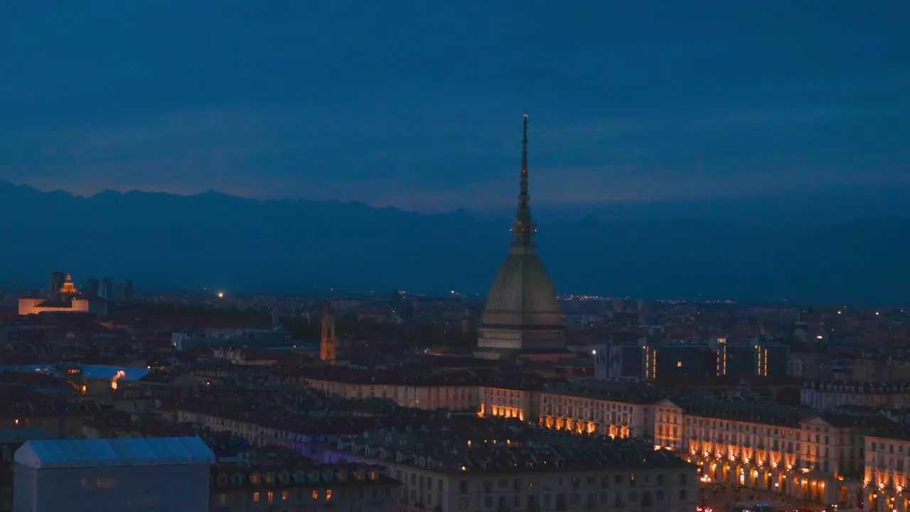 Night View of Torino Cityscape in Italy With Mole Antonelliana Building and Alps Mountains in Horizon