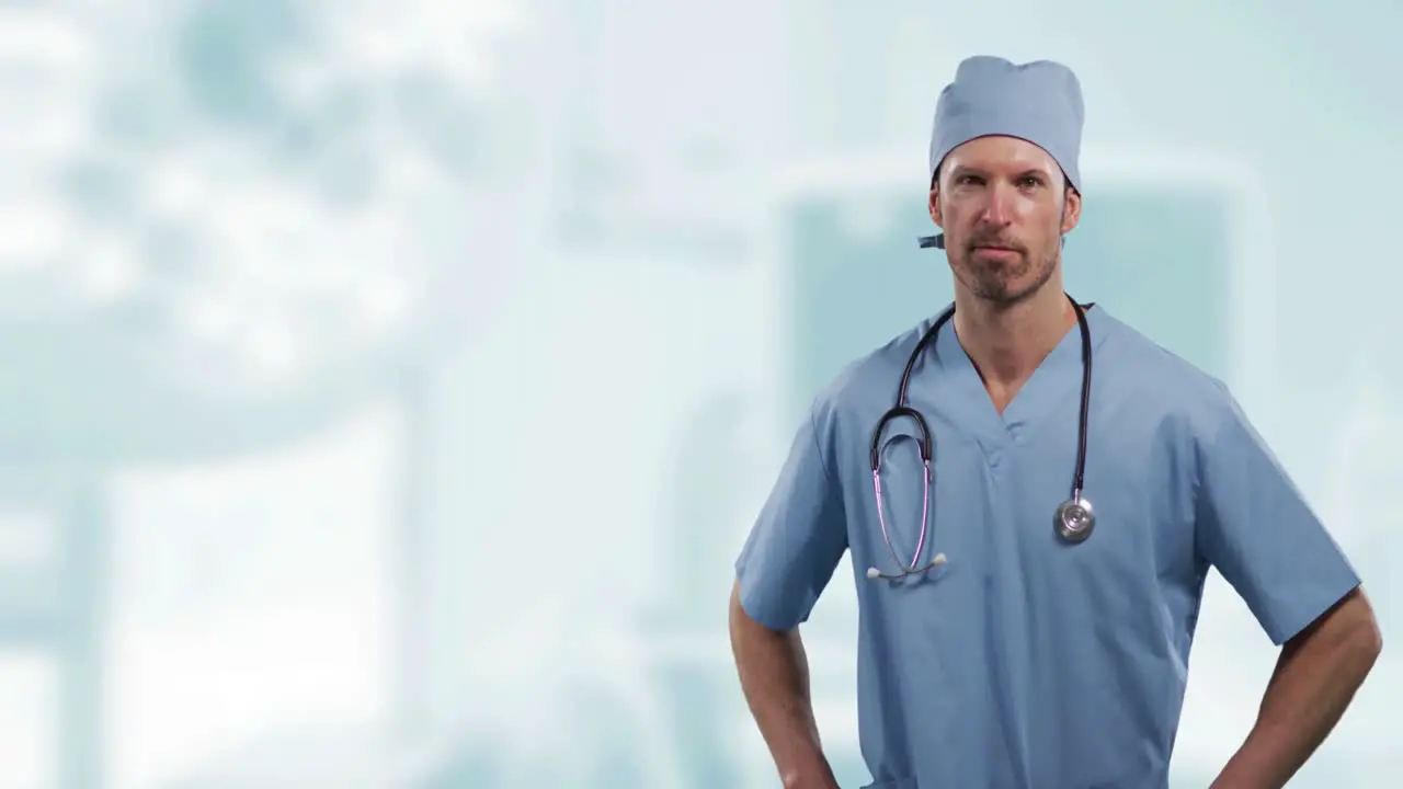 Portrait of caucasian male surgeon with hands on his hips against hospital in background