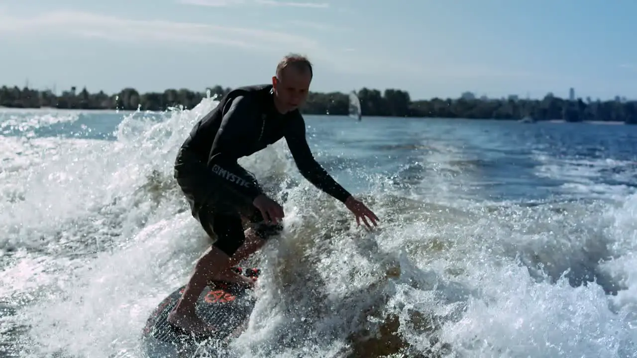 Wake surfing rider enjoy waves Sportsman surfing on waves in slow motion