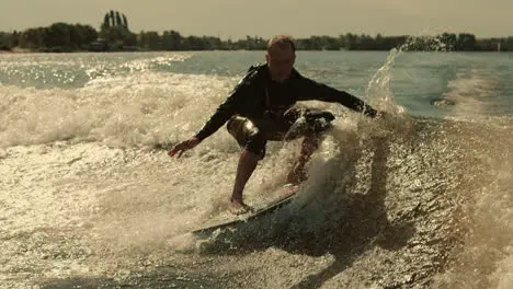 Wake surfing rider training stunt Wakesurfer falling into water