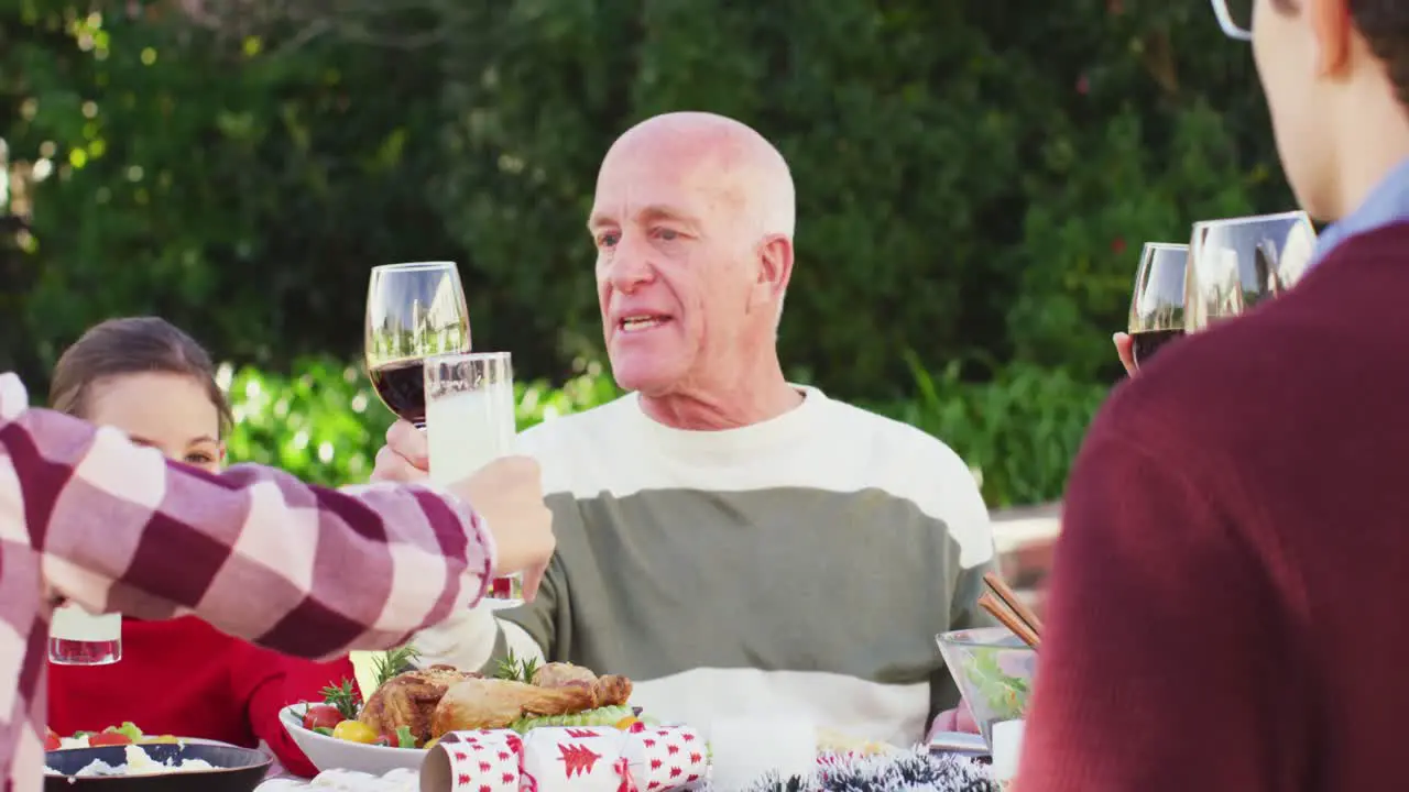 Happy caucasian family having dinner in garden