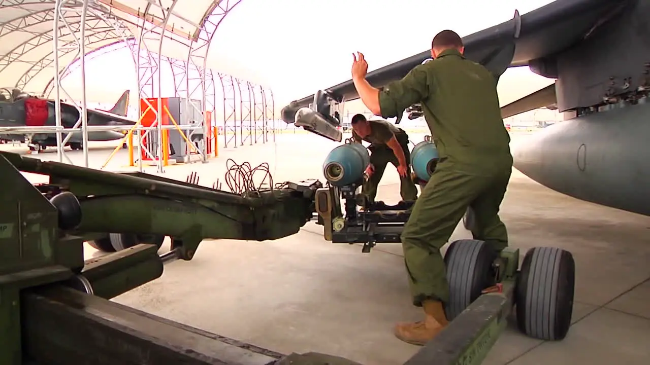 Bombs Are Loaded Onto A Jet Aircraft By Military Personnel 2