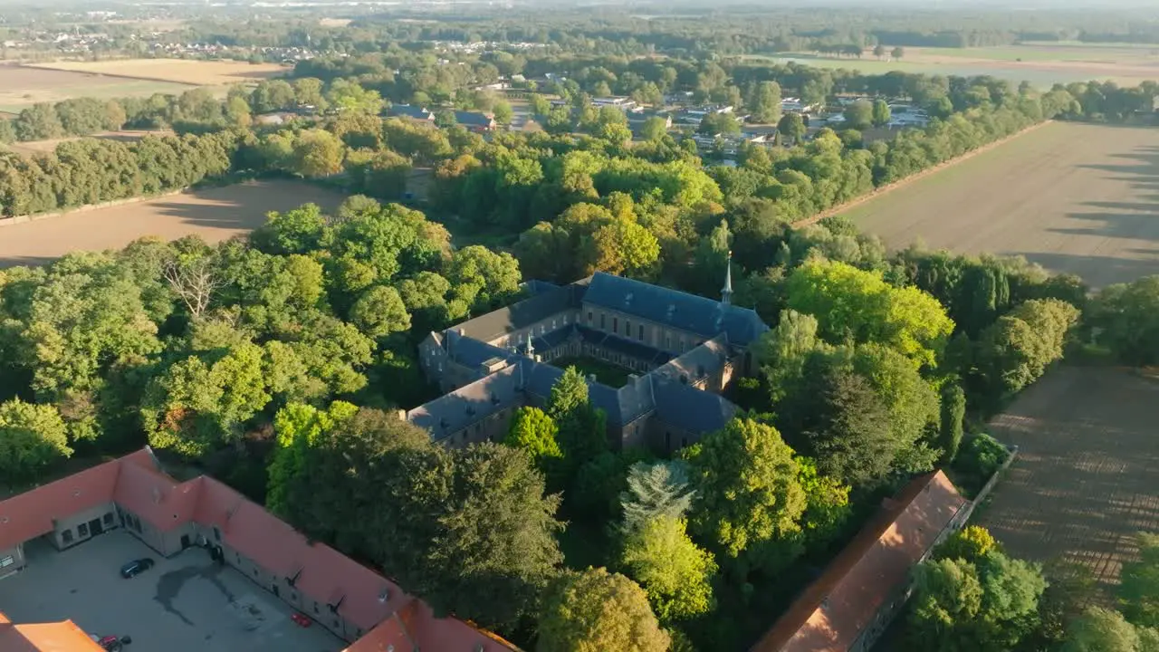 Amazing scenery of a monastery in the middle of the nature surrounded by trees drone shot