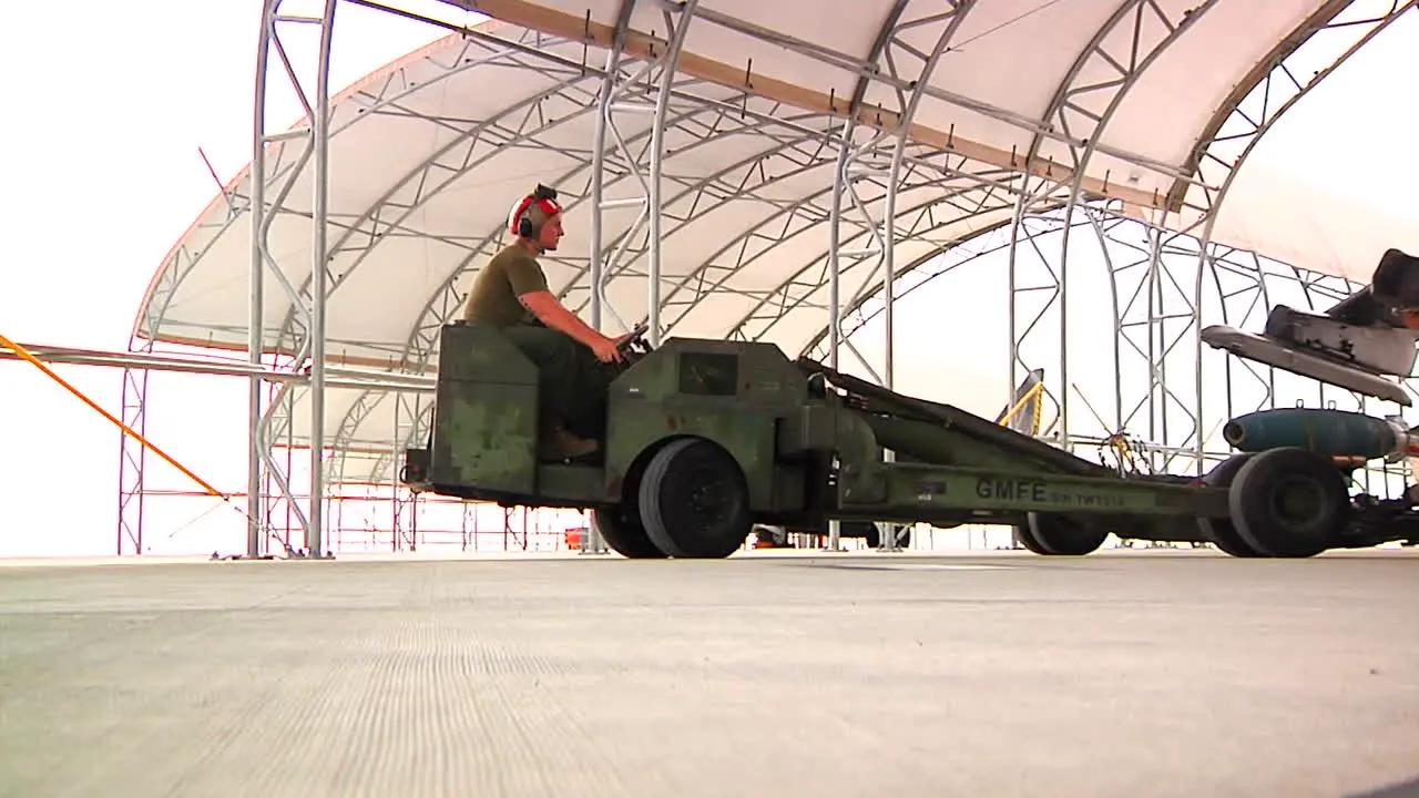 Bombs Are Loaded Onto A Jet Aircraft By Military Personnel 4