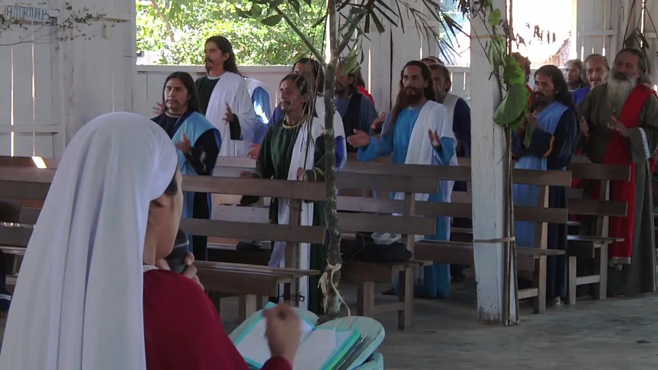 Group Of Adult Catholic Males Praying And Clapping Together Inside Open Church