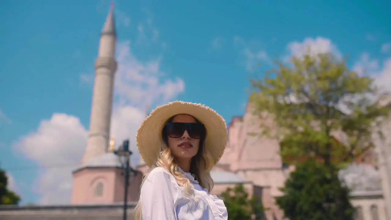 Slow MotionBeautiful young girl poses in front of an ancient building in Istanbul Turkey Travel concept