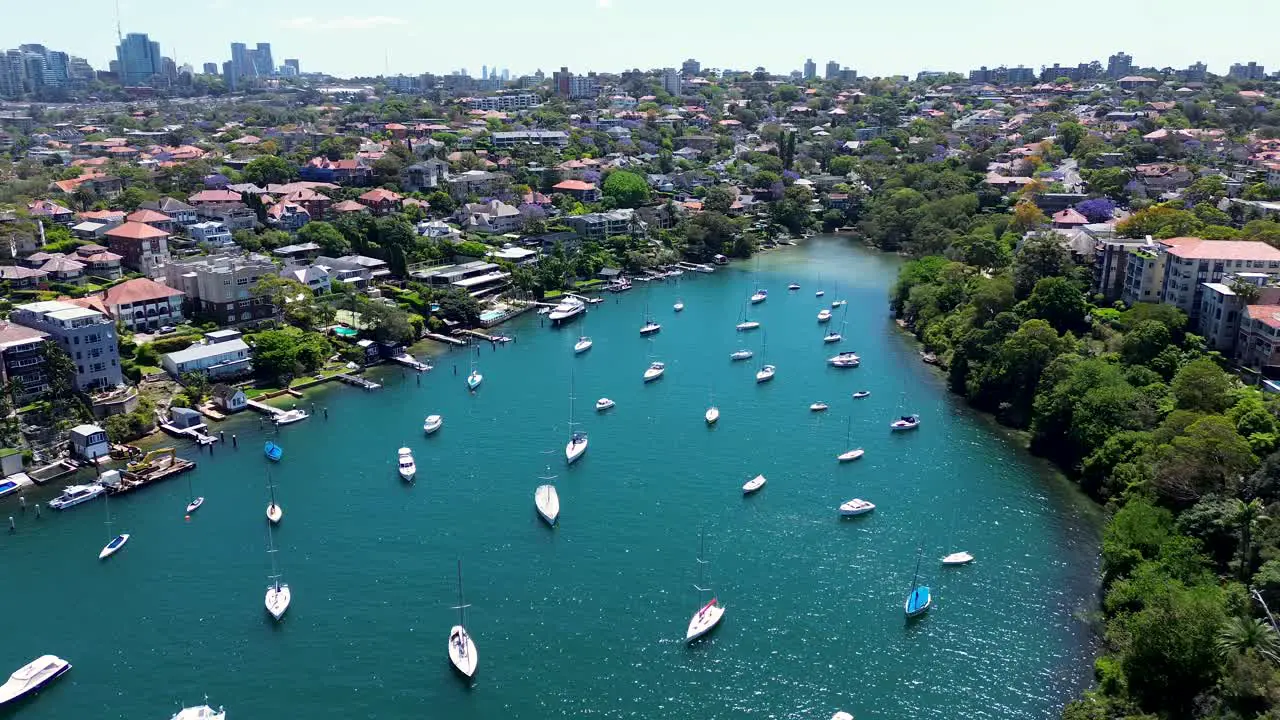 Drone aerial scenic view Mosman Bay Cremorne Point North Sydney Neutral bay yachts boats dock Sydney City harbour urban housing apartment residential wharf sea NSW Australia 4K